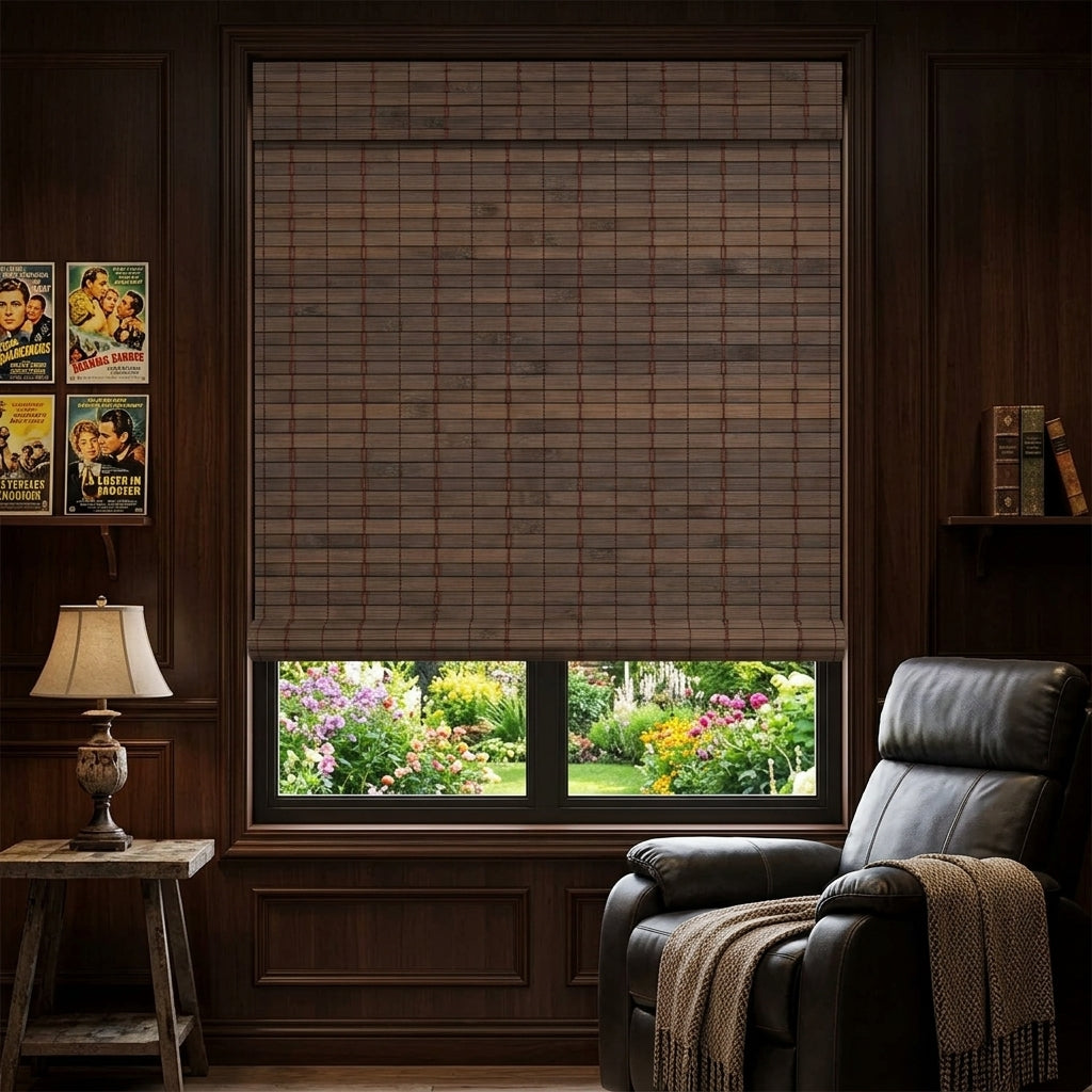 Dark woven bamboo shade over a window beside an upholstered chair
